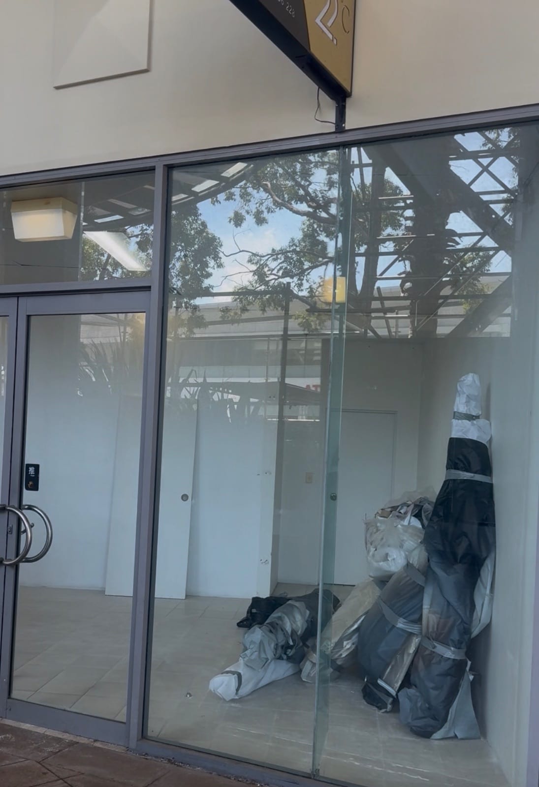 Removed plasterboard partitions wrapped for disposal to limit dust, Chatswood