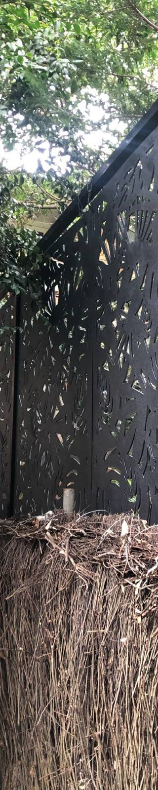 Decorative black privacy screen installed beside a pool in Wollstonecraft